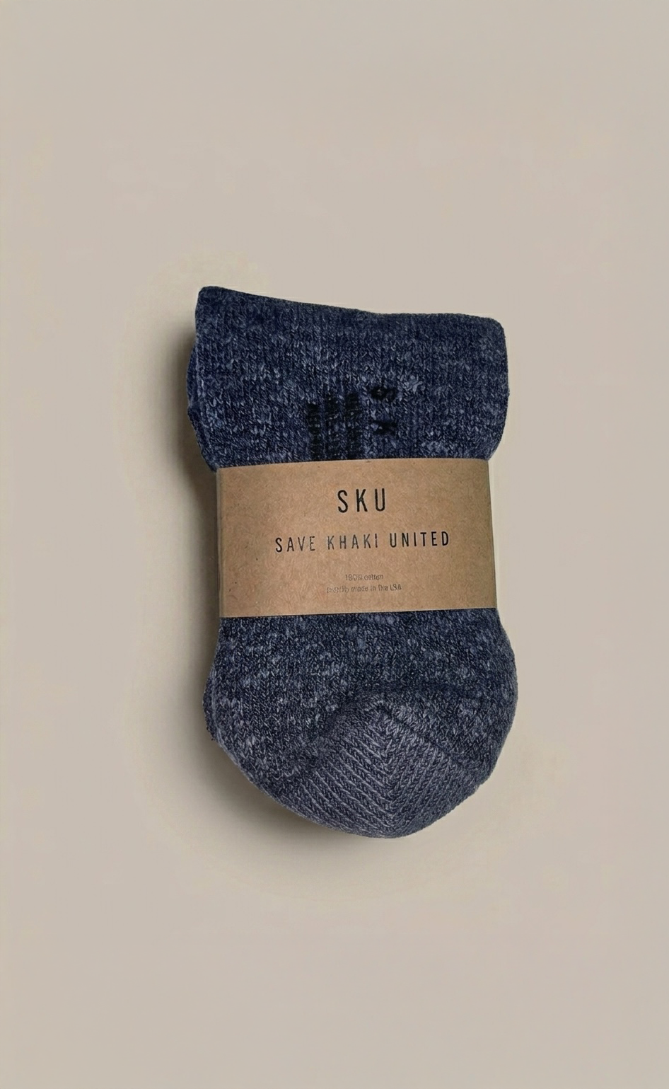 Single heather navy ankle sock with ribbed cuff and knit texture, kraft label