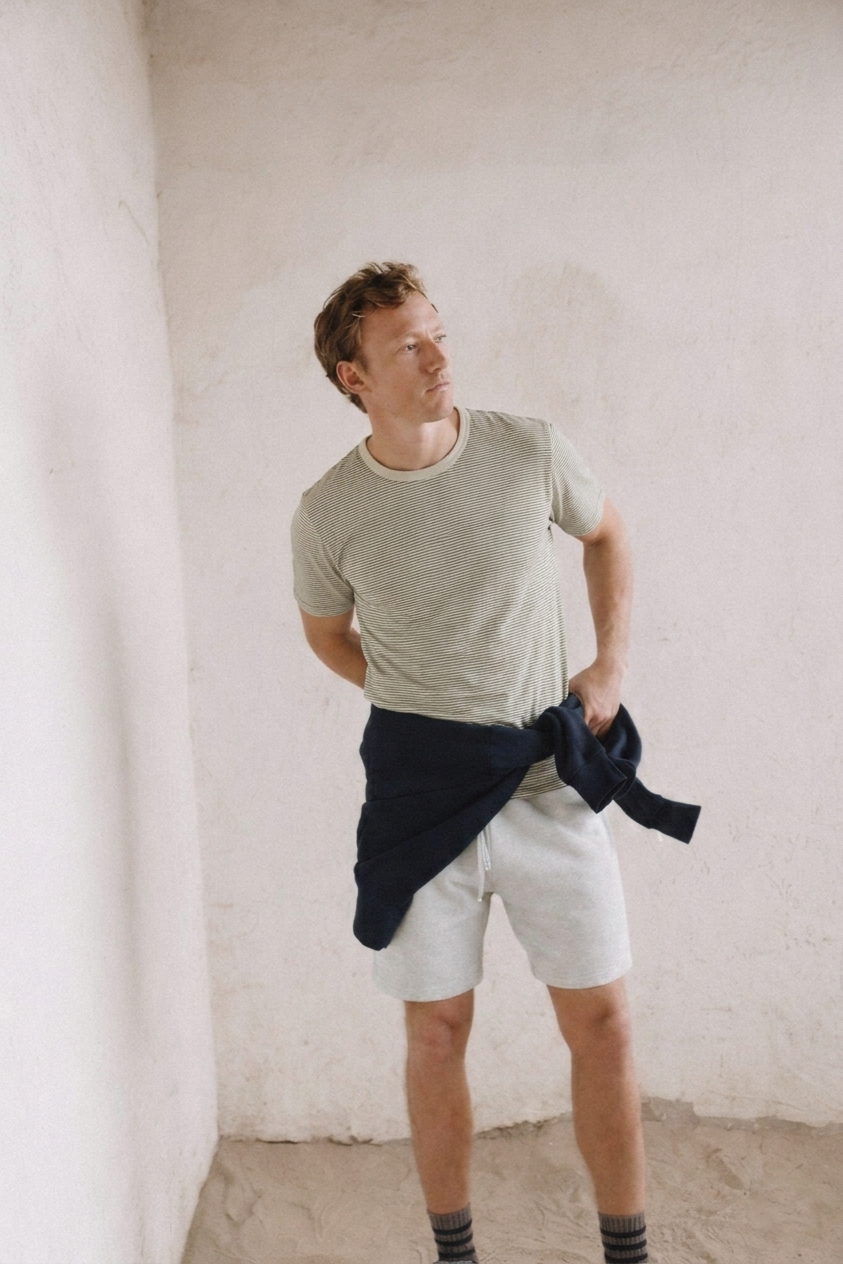 Heather gray jersey T-shirt with crew neck and short sleeves, worn by a model