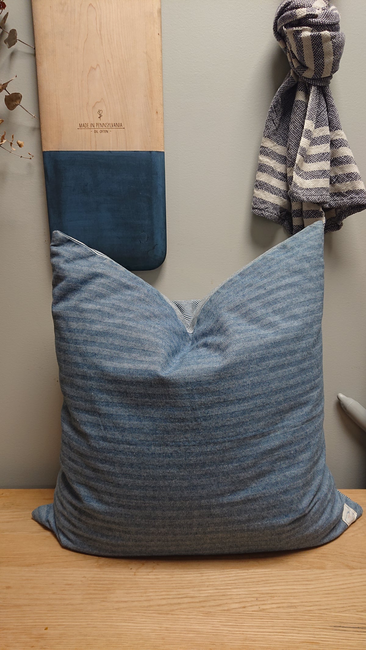 Indigo herringbone throw pillow with V seam and solid stripe accent